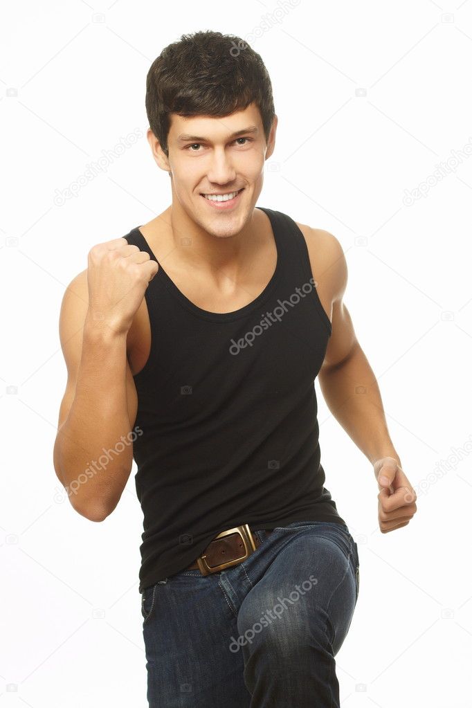 Successful muscled young man showing thumb up and smiling isolated