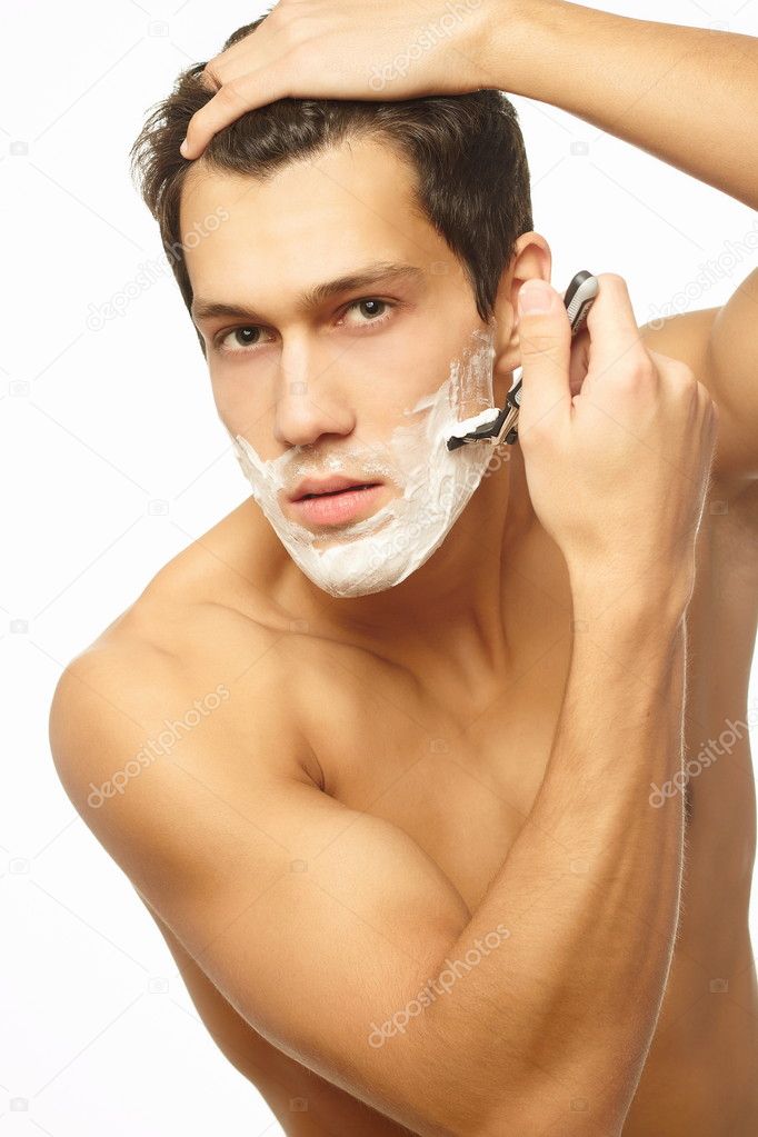 Sexy handsome young man with a shaving foam