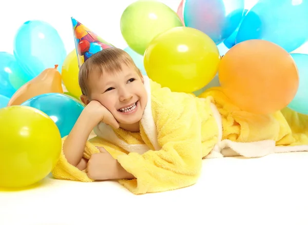 Smiling little boy in dressing gown celebrates his birthday — Stock Photo, Image