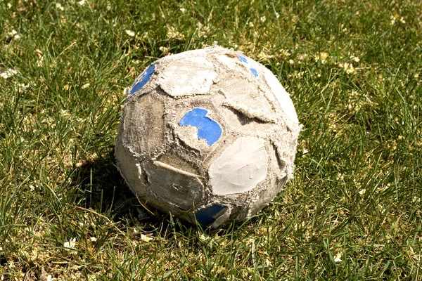 Old soccer ball on the field — Stock Photo, Image