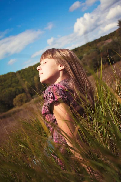 stock image Girl sitting on the green grass