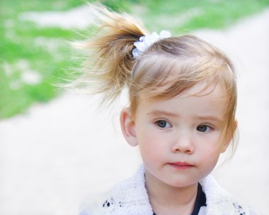 Portrait of the little thoughtful girl clipart