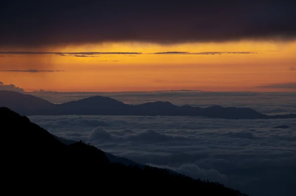 stock image Cloudscape over mountains at sunrise sunset