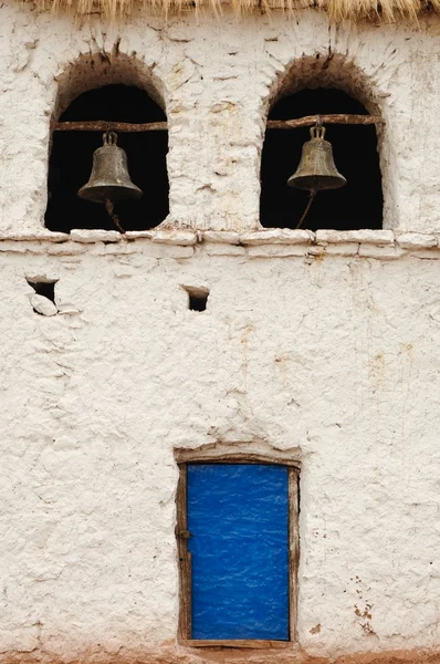 White wall with blue door and two bells — Stock Photo, Image