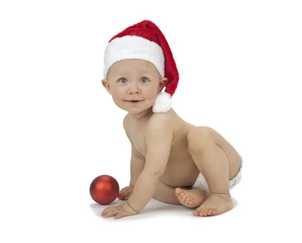 Ребенок в рождественских украшениях и шляпе Санты — стоковое фото