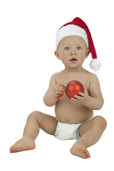 Child with Christmas decoration and Santa hat — Stock Photo, Image