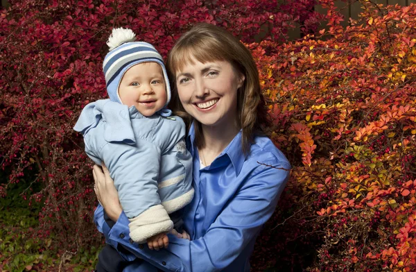 Mother and son on Fall background — Stock Photo, Image