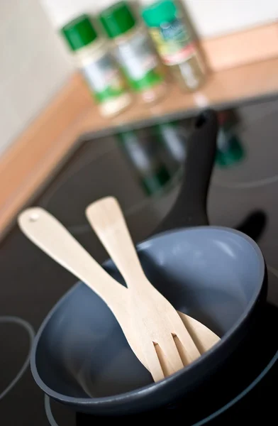 Sartén con utensilios de cocina en una estufa —  Fotos de Stock