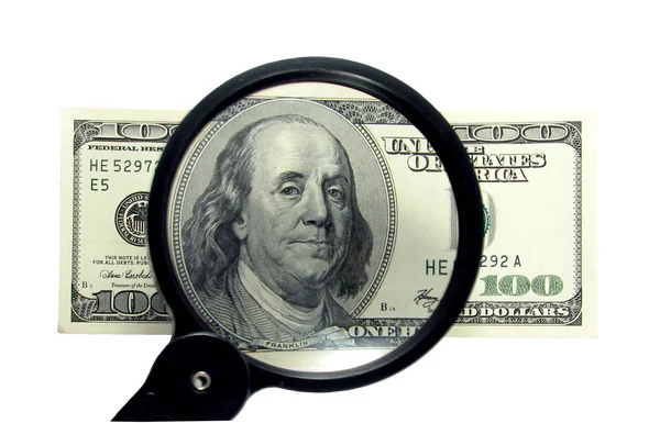 Money and magnifying glass Stock Image