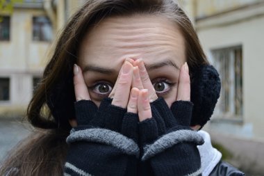 Expression of fear on his face young girl covers her mouth with clipart