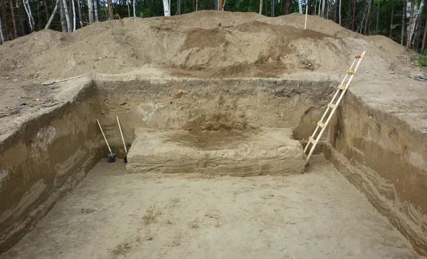 Stock image A deep hole dug during archaeological excavations, view from bel