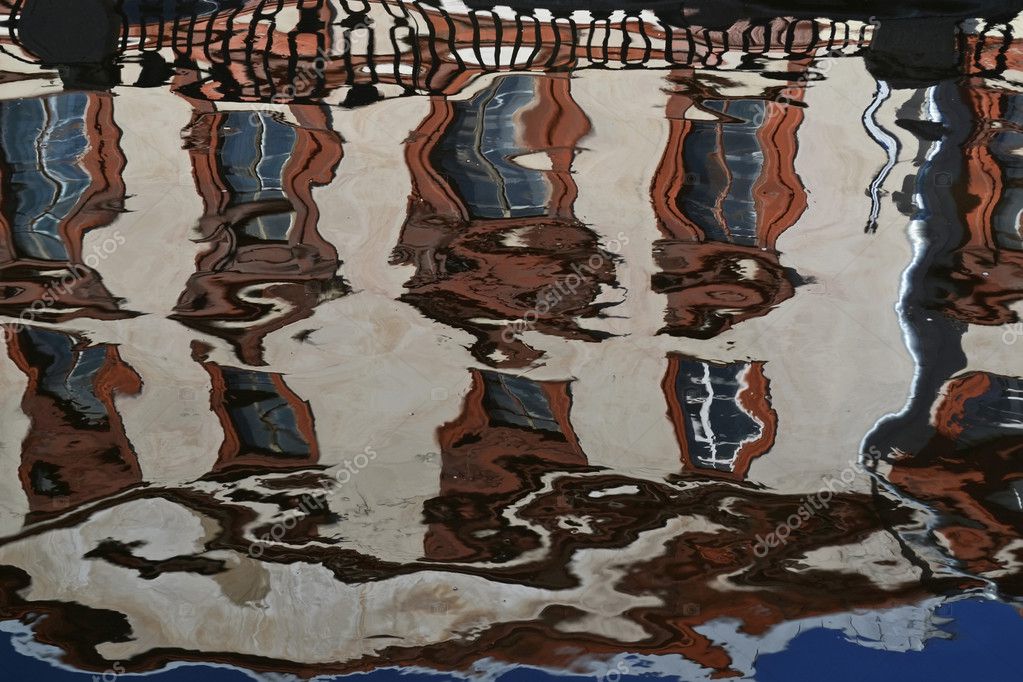 Distorted reflection in the water of a large building — Stock Photo ...