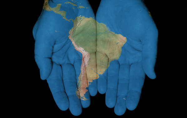 Map painted on hands showing concept of having South America in our hands