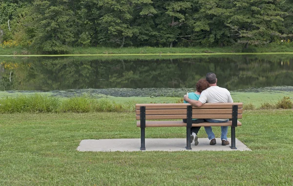 stock image Couple Sitting On a Bench In Spring