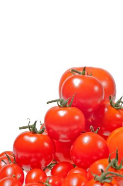 Variety of tomatoes piled up and isolated on white background clipart