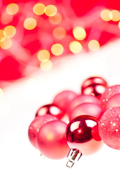 Red Christmas baubles over white and red — Stock Photo, Image