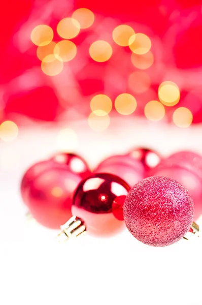 Red Christmas baubles over white and red background — Stock Photo, Image