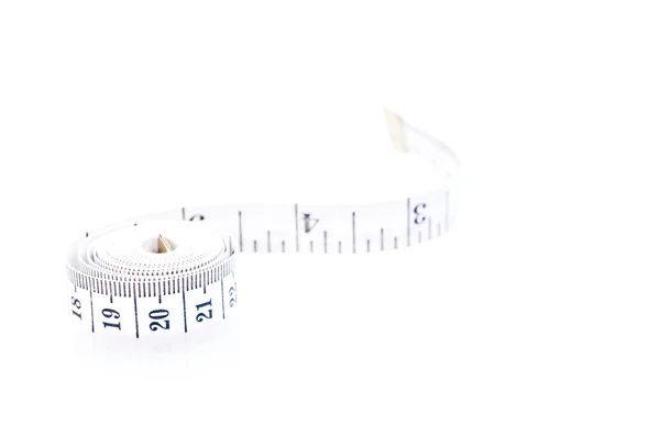 Rolled black and white tape measure over white — Stock Photo, Image