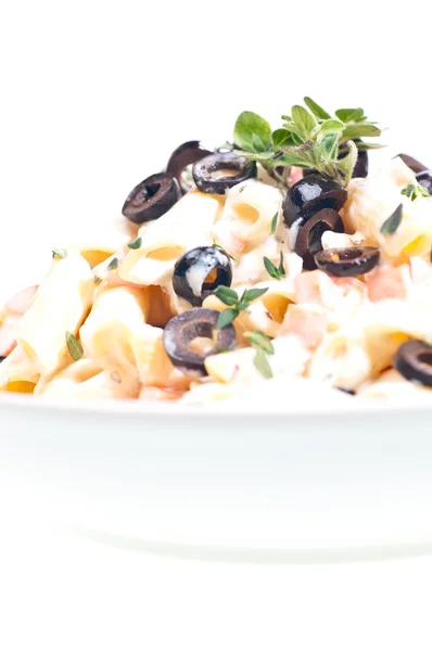 Penne pasta with cream vegetable sauce and olives — Stock Photo, Image