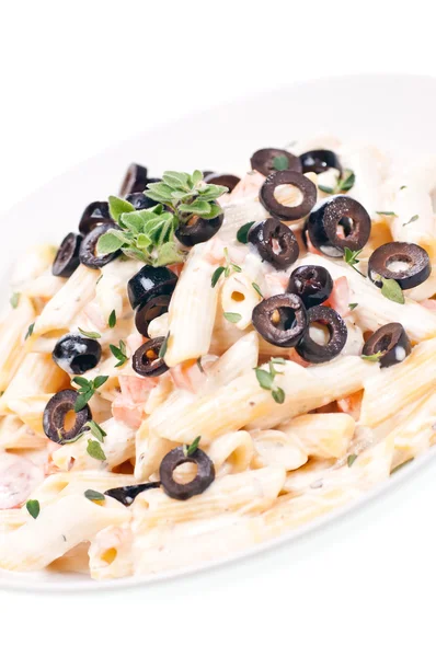 Penne pasta со сливочным соусом и оливками — стоковое фото