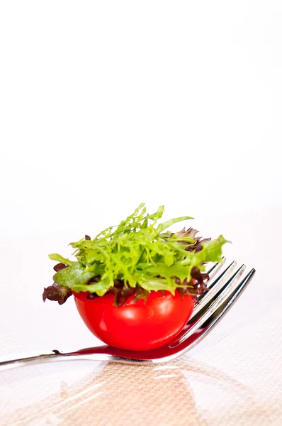Fresh tomato and salad canape on a fork — Stock Photo, Image