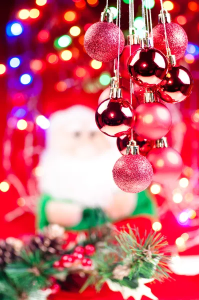 Red Christmas hanging baubles with santa at the background — Stock Photo, Image