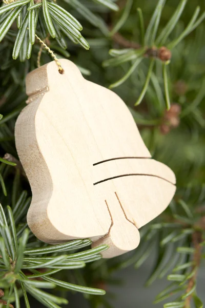 Wooden bell hanging on Christmas tree — Stock Photo, Image