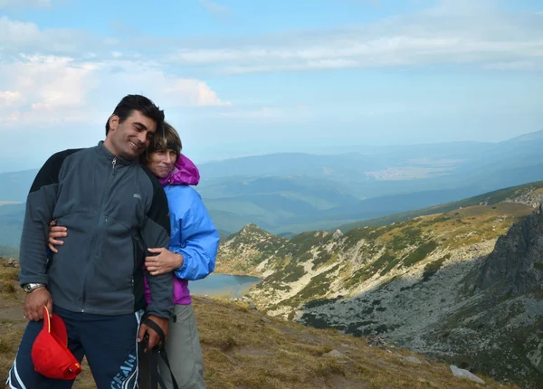 Mountain embrace: Couple in love on the top of Seven Rila lakes
