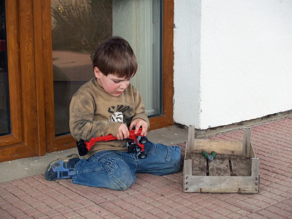 Pojke reparera sin leksaksbil — Stockfoto