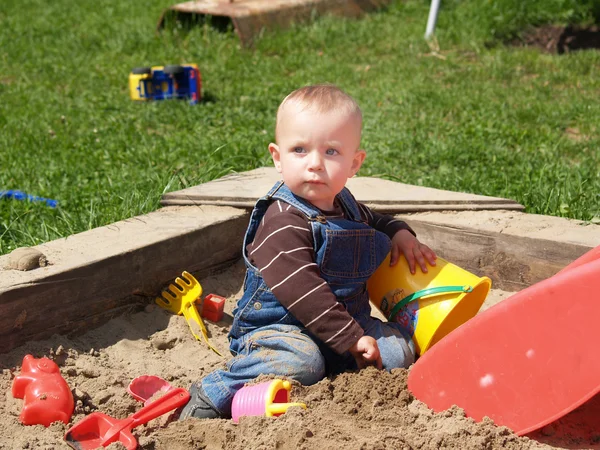 Girl in sand-pit — Stock Photo, Image