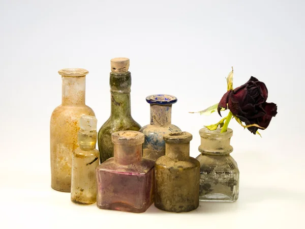 Dirty bottles with rose — Stock Photo, Image