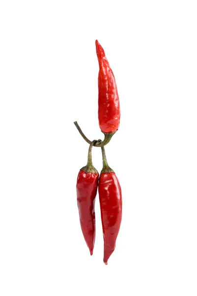 En röd peppar lyfter två peppar — Stockfoto
