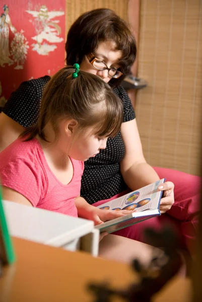 Mamá con una hija leyó el libro — Foto de Stock