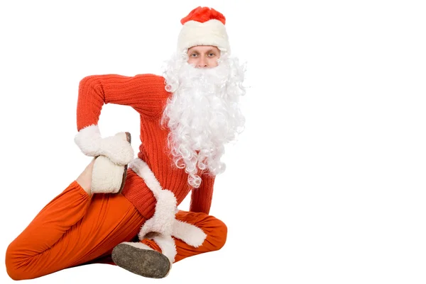 Санта-Клаус сидит на полубечевке и растягивает — стоковое фото