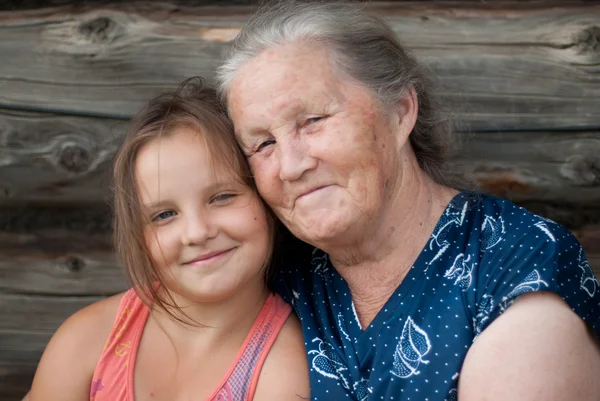 The elderly woman with the grand daughter — Stock Photo, Image