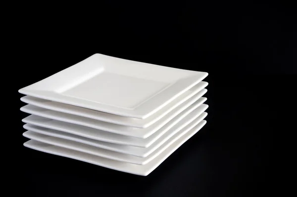 White Plates on Black — Stok fotoğraf