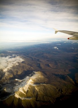 Flying Above Mountains at Sunset clipart