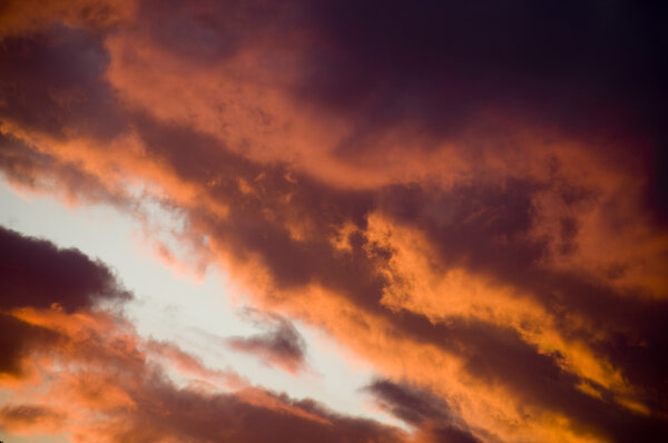 Sunset clouds in intense shades of red, orange and black
