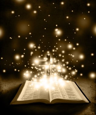 Glowing Bible with Cross on Brown Backround clipart