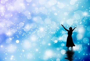 A woman praising in snowy backround clipart