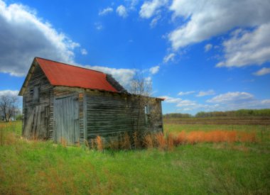 Old barn in the grassy field clipart