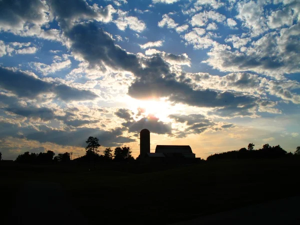 Old Barn and silo silhouetted — Stock Photo, Image