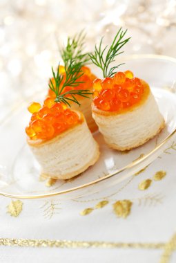 Vol-au-vents filled with red caviar clipart