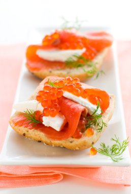 Salmon appetizer with red caviar clipart