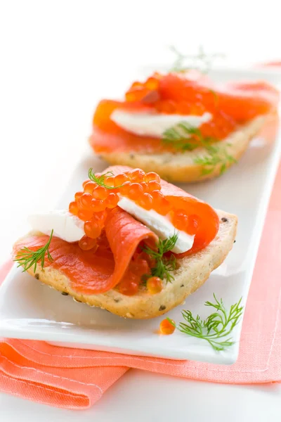 Salmon appetizer with red caviar — Stock Photo, Image