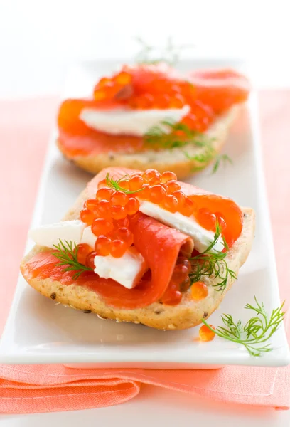 Salmon appetizer with red caviar — Stock Photo, Image