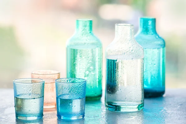 stock image Bottle of water and glasses of water