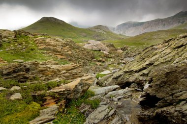 Mountain landscape with stones in foreground clipart