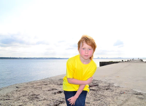 Funny boy on a sea pier — Stock Photo, Image