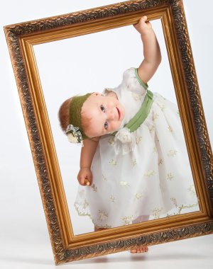 Portrait of a girl with the frame. Little funny girl looking through the fr clipart